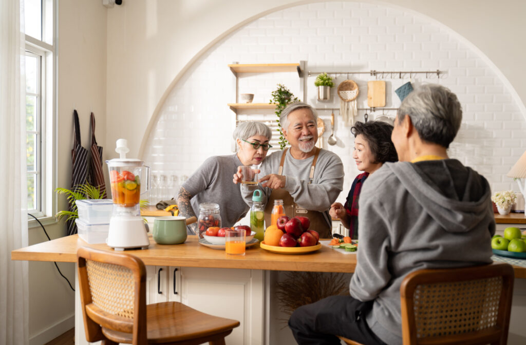 A group of seniors making fruit and vegetable juice in the kitchen