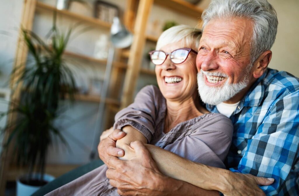 A senior couple hugs and smiles after choosing the perfect independent living community.
